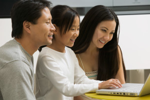 Parents teaching child about computer safety and cyberbullying